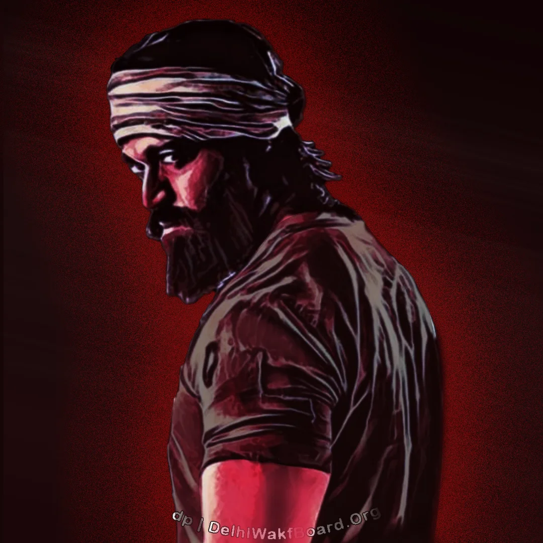 A lead character Rocky(Yash) Bhai from the movie Kolar Gold Fields (KGF). He is standing and in a danger and aggressive look.